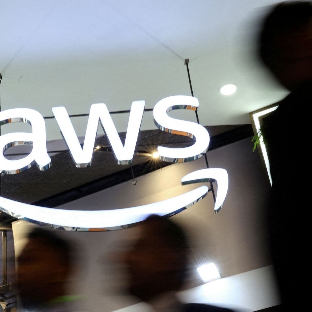 La gente pasa junto al logotipo de Amazon Web Services (AWS) en un centro de convenciones en India, el 8 de octubre de 2025. Foto: Reuters