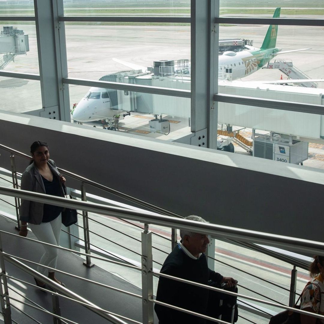Pasajeros abordan vuelo de Mexicana en el AIFA