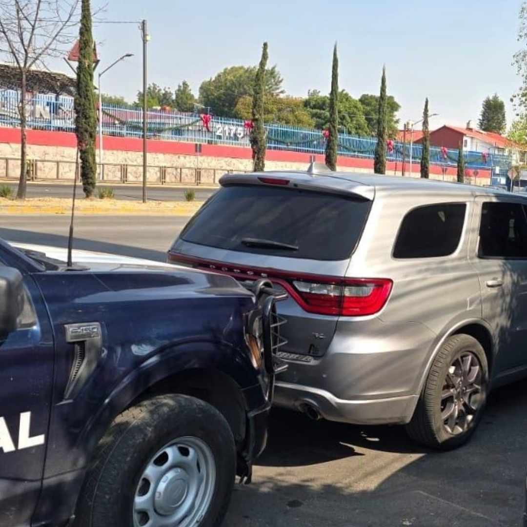 Dos patrullas rodean un carro.