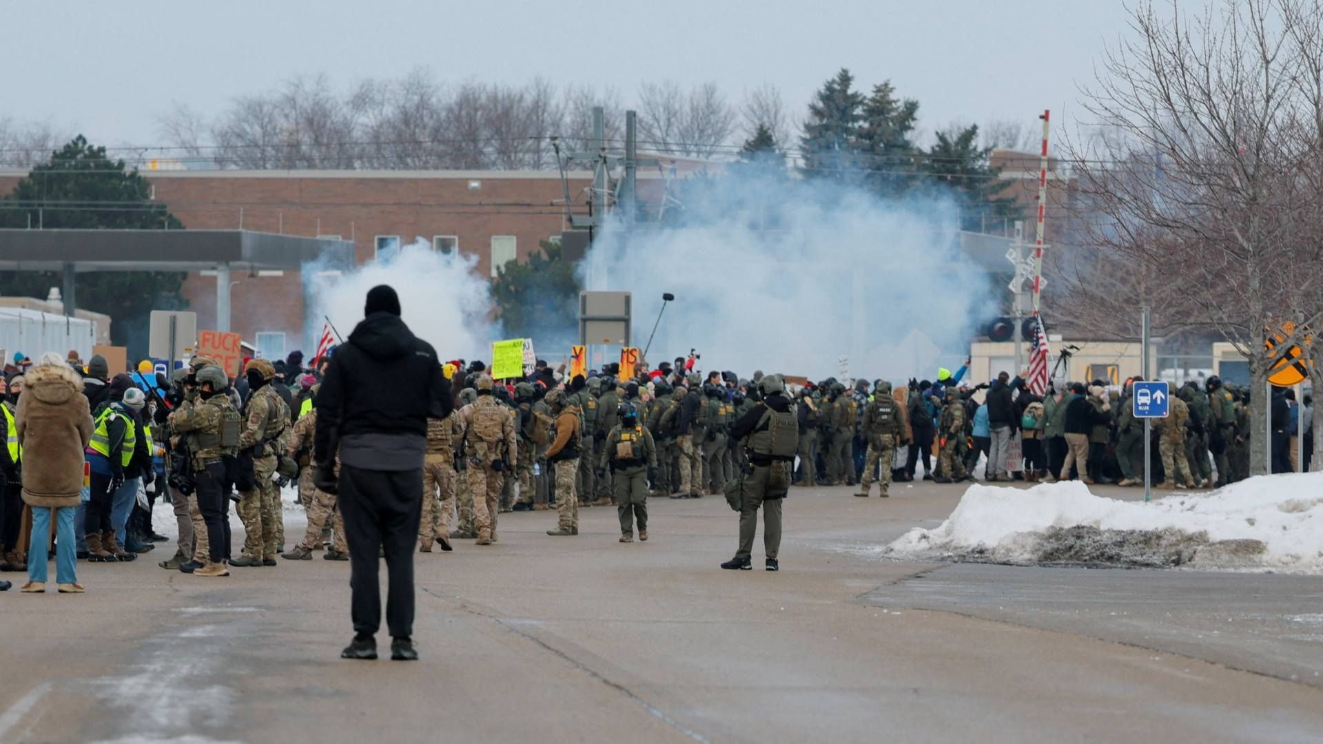 Manifestantes se mantienen en medio de gases lacrimógenos mientras participan en una protesta contra el tiroteo fatal de Renee Nicole Good. Foto: Reuters