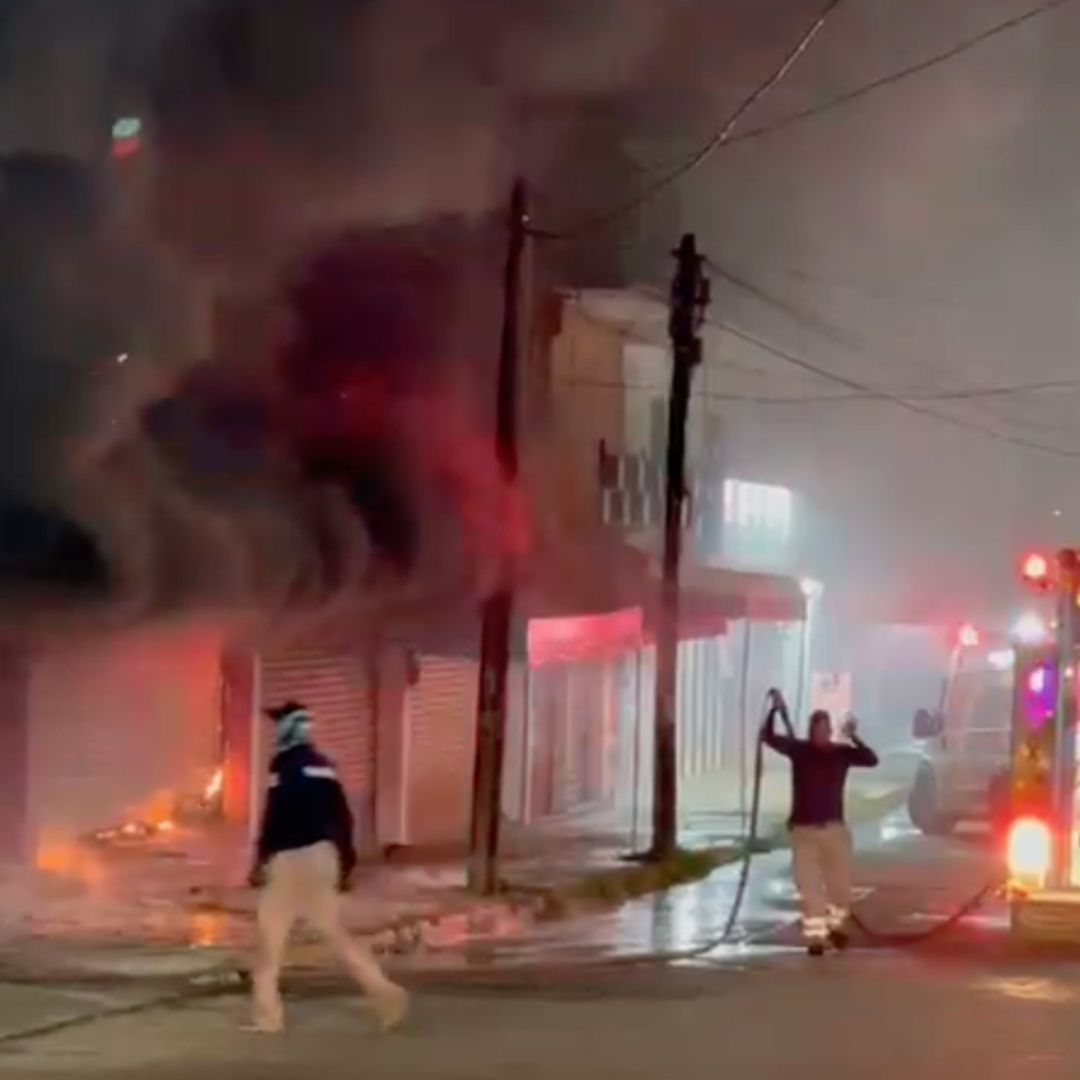 Bomberos combaten incendio en de locales comerciales atacados con bombas caseras en Acayucan.