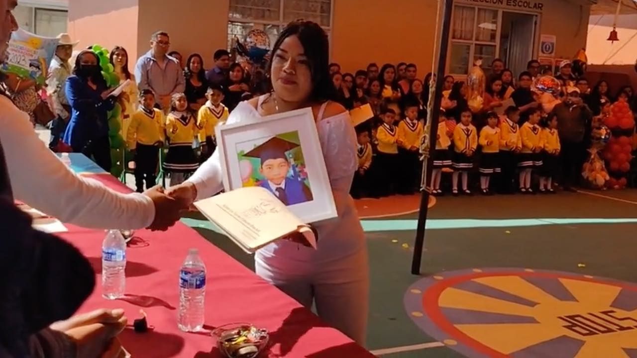 Madre leva foto de su hijo muerto a graduación del kínder