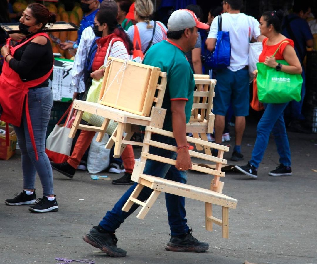 Vendedor de sillas en bullicioso mercado
