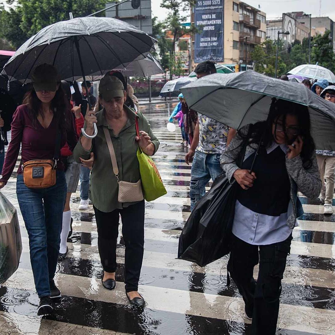 Ciudadanos se cubren de las lluvias en la CDMX el 16 de junio de 2025