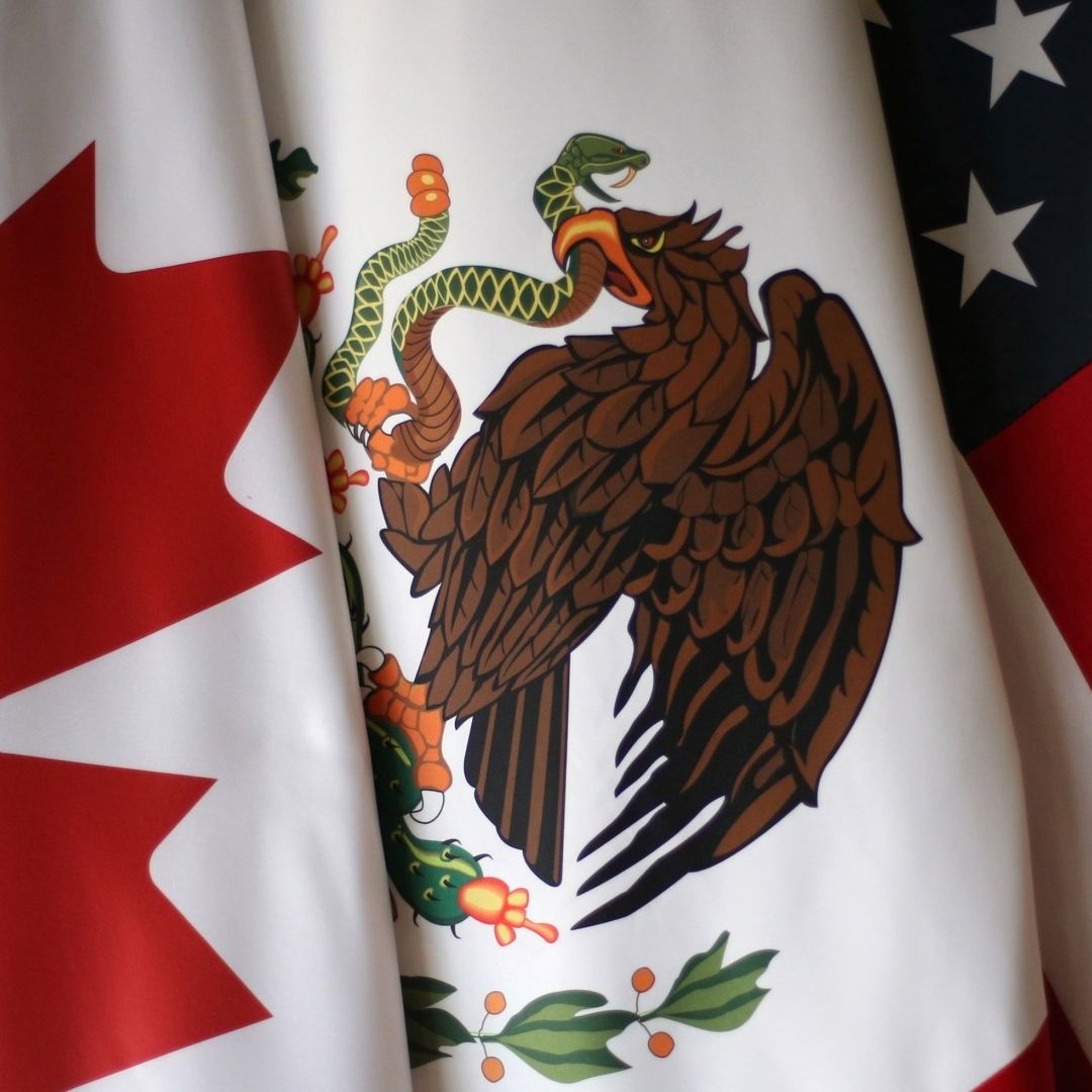 Banderas de Canadá, México y Estados Unidos, integrantes del T-MEC