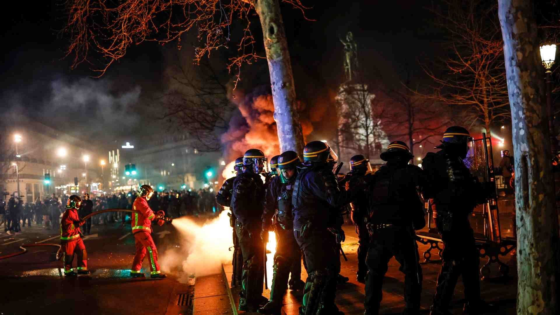 Bomberos franceses apagan un incendio durante los enfrentamientos con la policía antidisturbios durante manifestación contra reforma de las pensiones