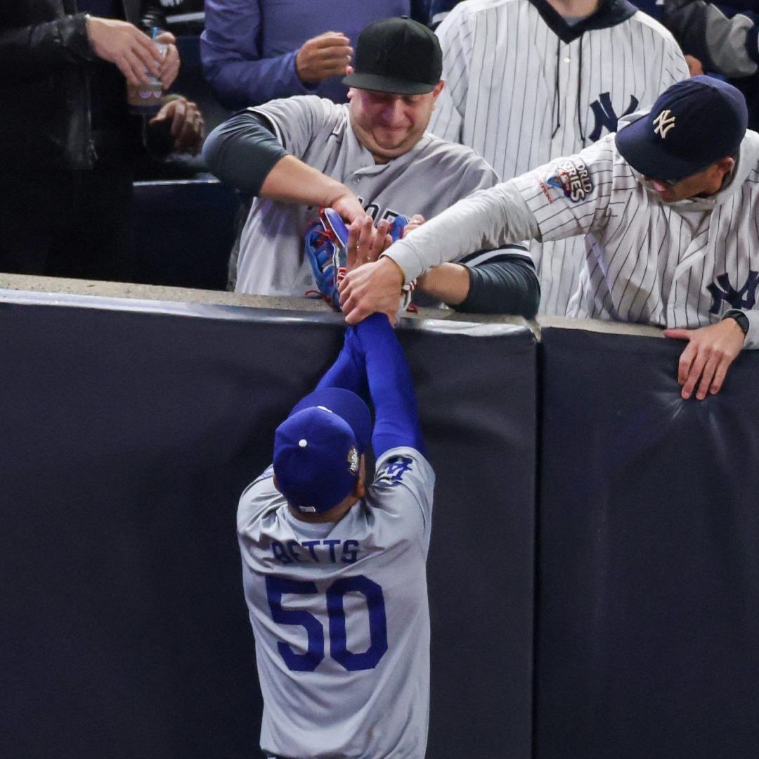 Mookie Betts quedó 'atrapado' entre dos aficionados de Yankees. Foto AFP