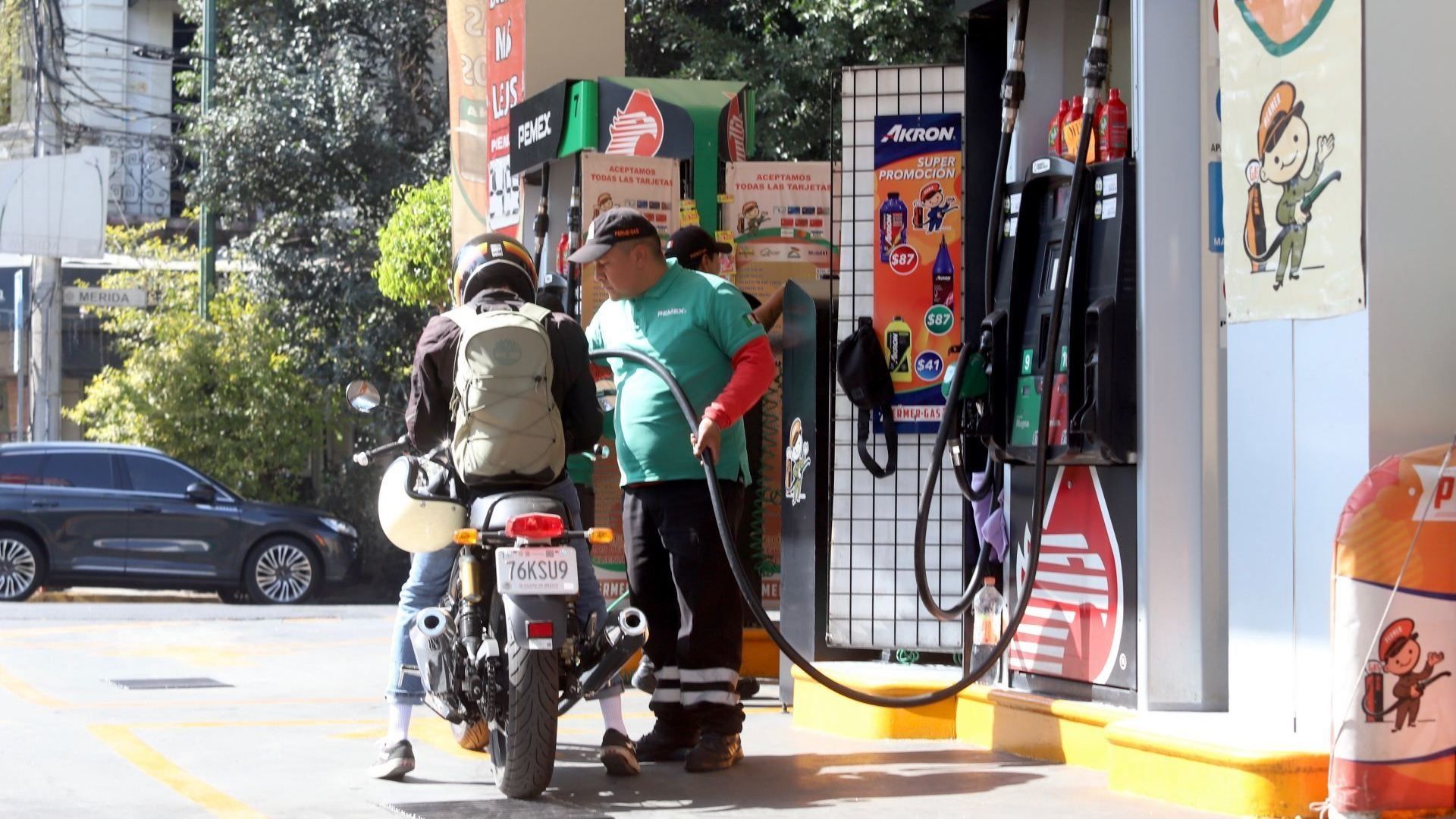 Motociclista carga gasolina en una estación de Pemex
