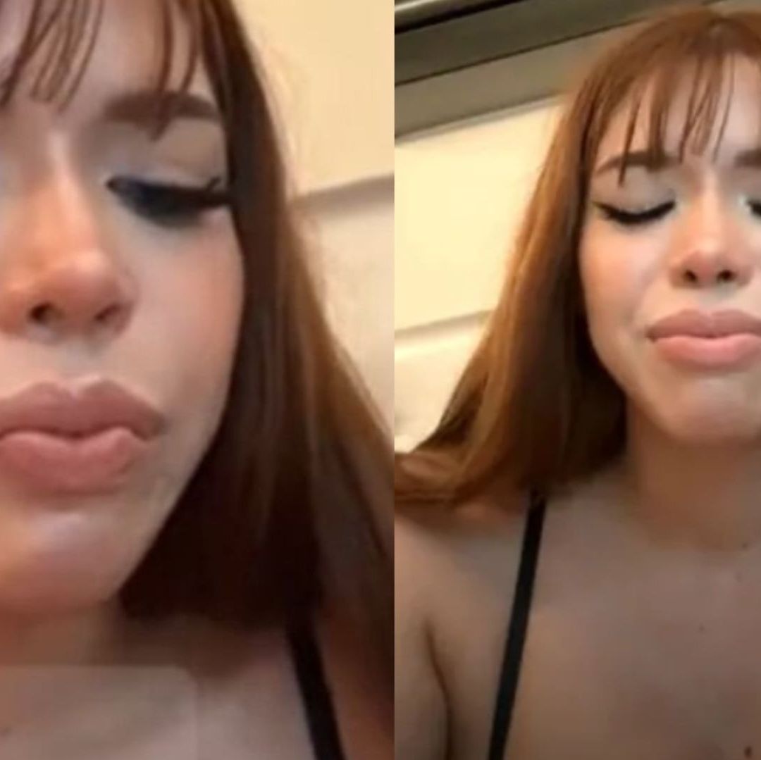 Una mujer con cabello pelirrojo con semblante triste.