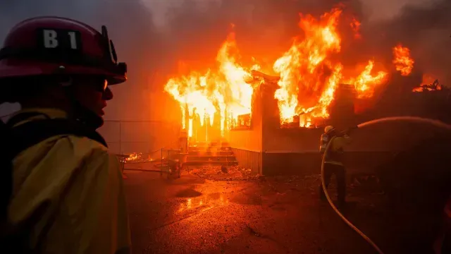 Elementos de servicios de emergencia combaten incendio en Palisades, en Los Ángeles, California.