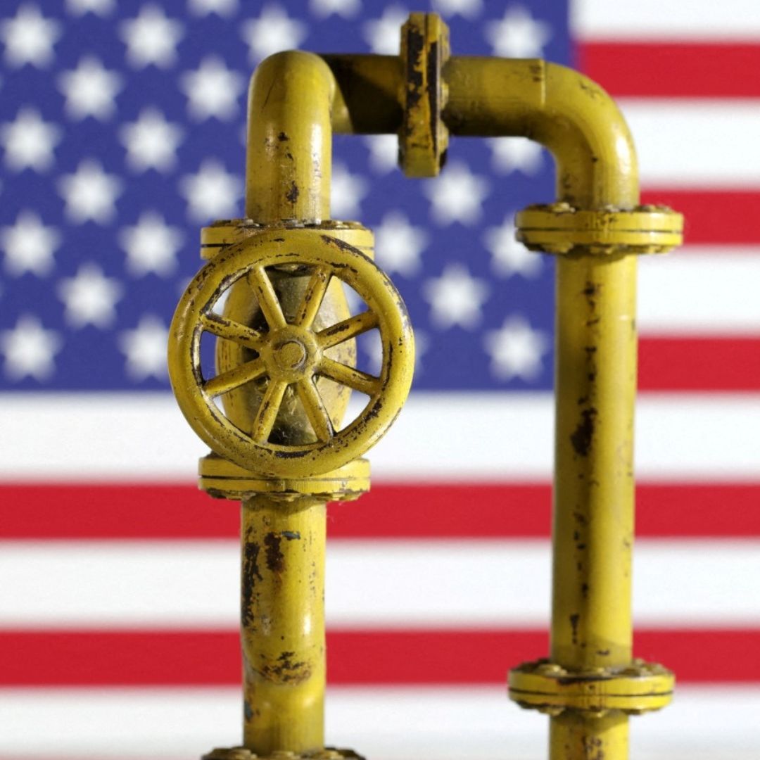 Maqueta de un gasoducto y la bandera de Estados Unidos