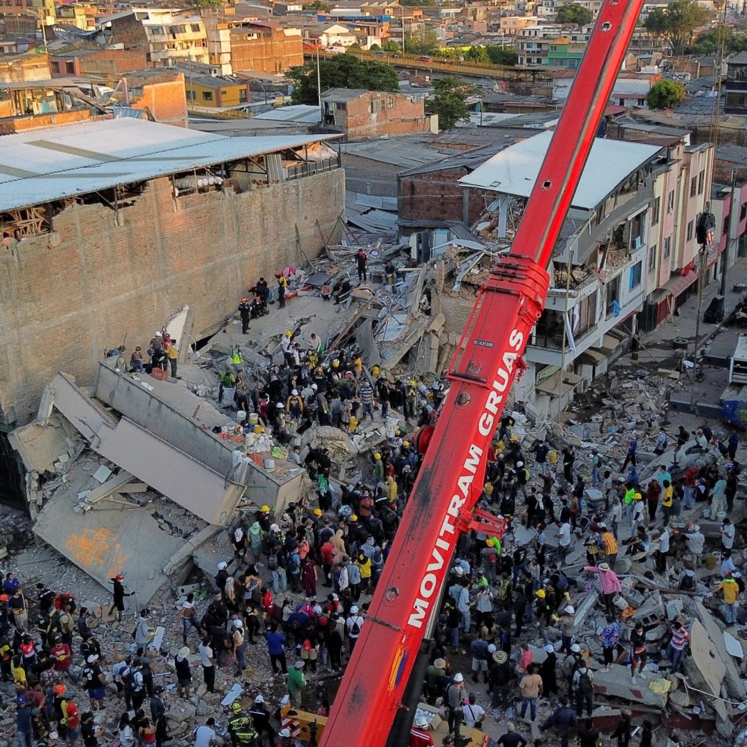 Equipos de rescate y voluntarios laboran en un edificio caído en Pereira, Colombia