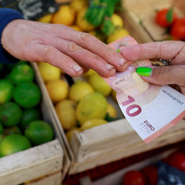 A shopper pays with a ten Euro bank note at a local market in Aix-en-Provence, France