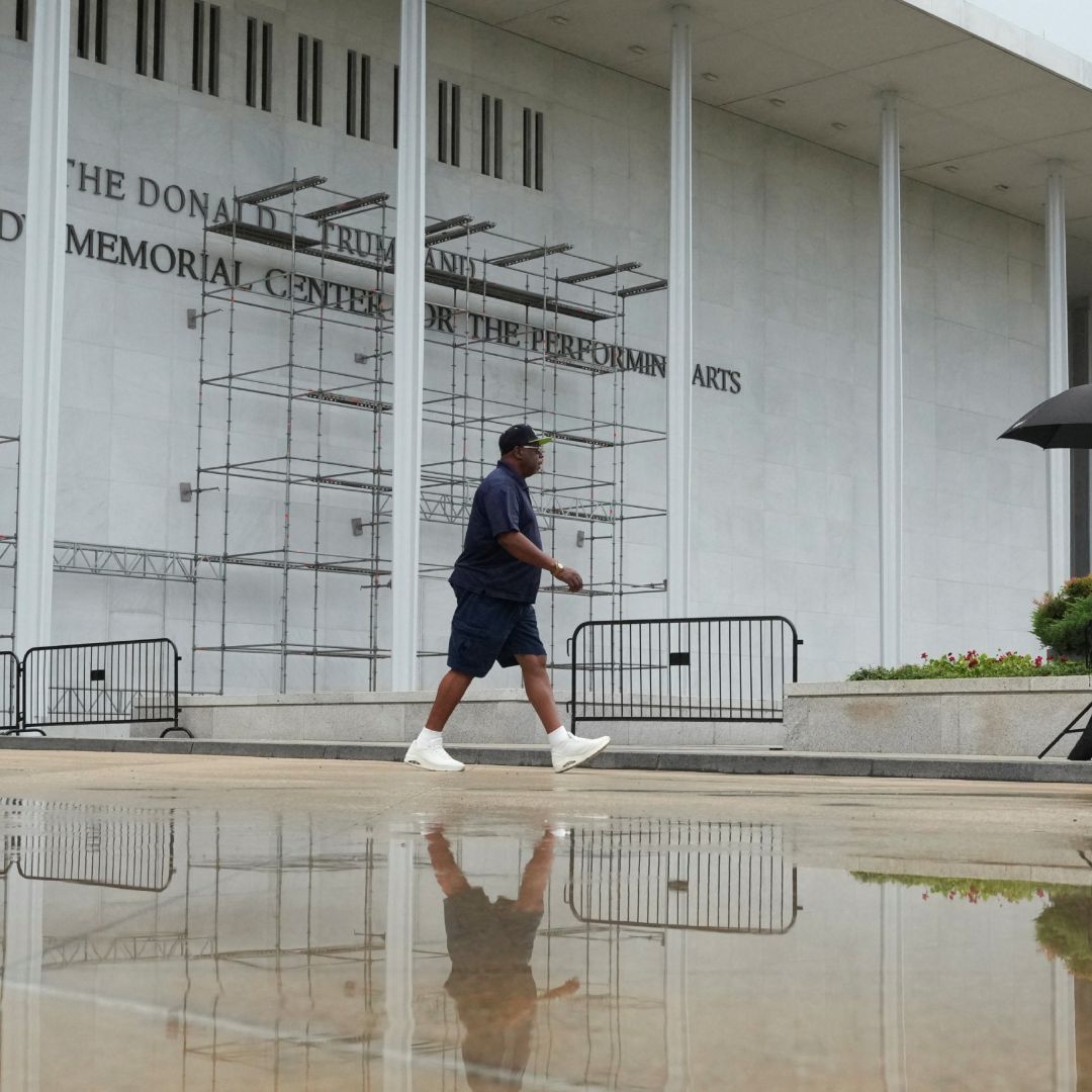 Un hombre camina frente al Centro Kennedy